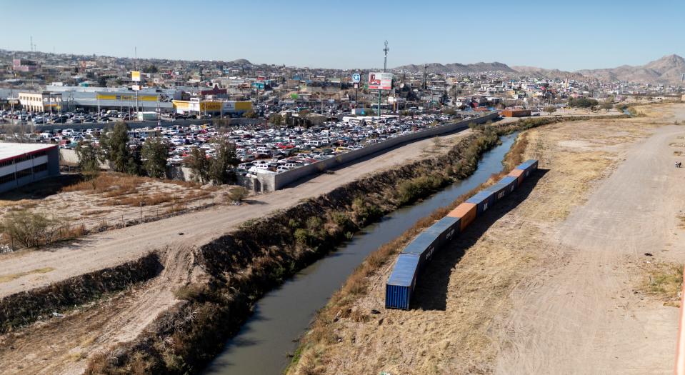 Shipping containers are seen as a makeshift border wall along the U.S.-Mexico border near downtown in El Paso, Texas, Saturday, December 24, 2022. 