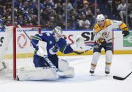 Nashville Predators' Luke Evangelista, right, watches as teammate Ryan O'Reilly, not seen, scores against Vancouver Canucks goalie Thatcher Demko during the second period in Game 1 of an NHL hockey Stanley Cup first-round playoff series in Vancouver, British Columbia, on Sunday, April 21, 2024. (Darryl Dyck/The Canadian Press via AP)