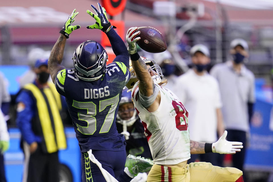 San Francisco 49ers tight end George Kittle (85) makes a catch as Seattle Seahawks free safety Quandre Diggs (37) defends during the second half of an NFL football game, Sunday, Jan. 3, 2021, in Glendale, Ariz. (AP Photo/Ross D. Franklin)