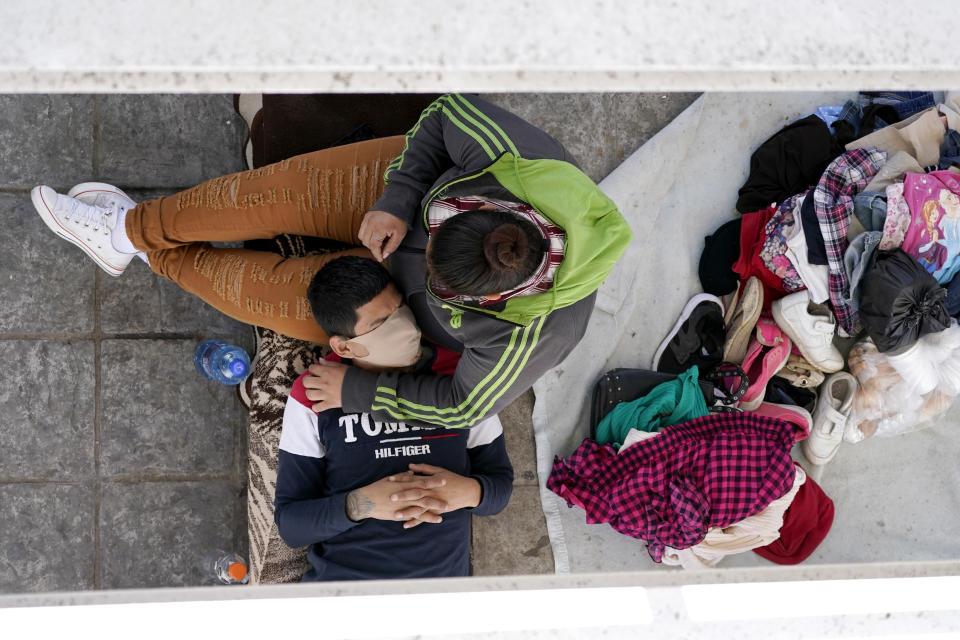 Migrants who were caught trying to cross into the U.S. and were deported rest under a ramp that leads to the McAllen-Hidalgo International Bridge on Thursday, March 18, 2021, in Reynosa, Mexico. The fate of thousands of migrant families who have recently arrived at the Mexico border is being decided by a mysterious new system under President Joe Biden. U.S. authorities are releasing migrants with “acute vulnerabilities” and allowing them to pursue asylum. But it’s not clear why some are considered vulnerable and not others. (AP Photo/Julio Cortez)