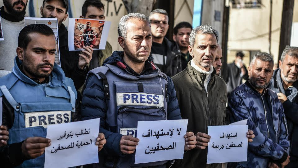 Members of the press, who try to perform their duties in the Gaza Strip, carry banners reading 'the press is free and cannot be silenced.' - Abed Zagout/Anadolu/Getty Images