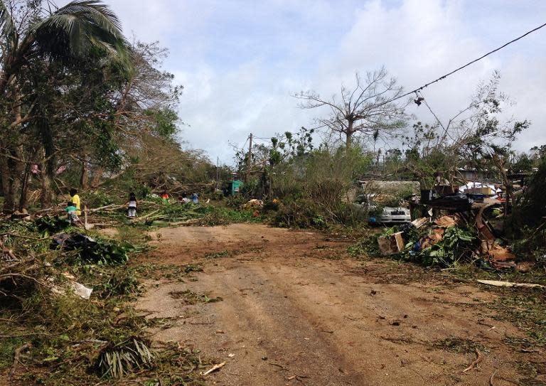 People clear up debris in Seaside, near the Vanuatu capital of Port Vila, in the aftermath of Super Cyclone Pam, on March 15, 2015