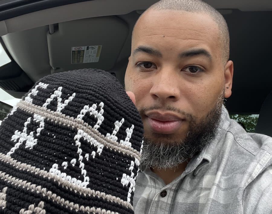 <em>Mike Rivers and the hat that he sent to Kyrie Irving (Courtesy of Mike Rivers) </em>