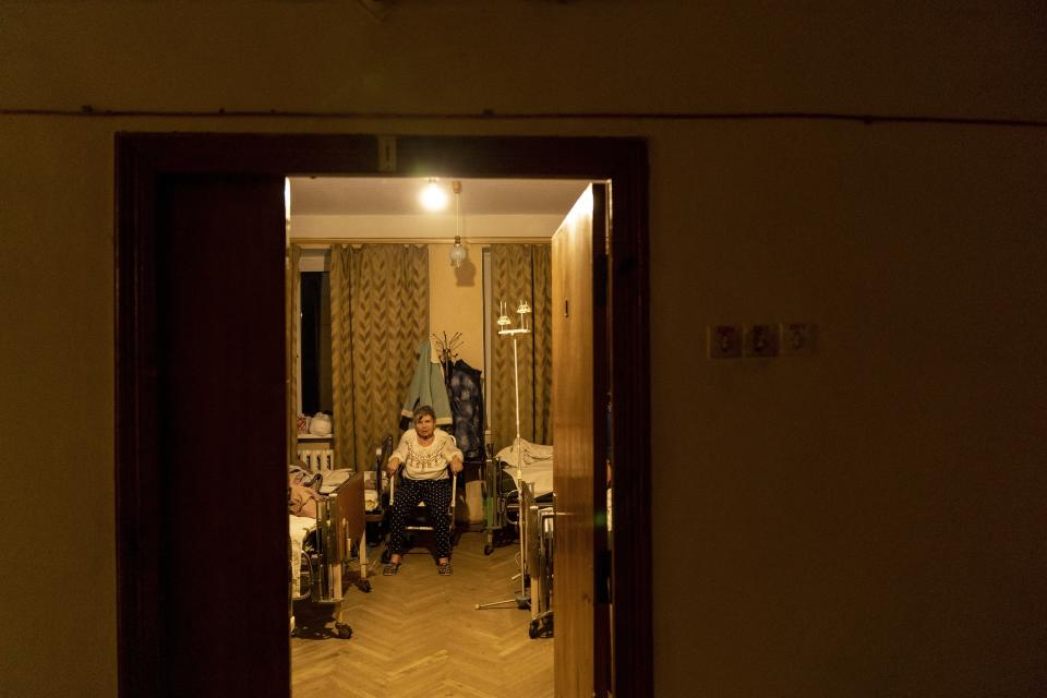 A patient with COVID-19 sits in a room at an hospital in Rudky, Western Ukraine, on Tuesday, Jan. 5, 2021. The government's wide-ranging lockdown closed schools, gyms and entertainment venues and prohibits table service at restaurants through Jan. 25. Ukraine, which has a population of 42 million, has reported more than 1.1 million confirmed coronavirus cases and nearly 20,000 deaths in the pandemic. (AP Photo/Evgeniy Maloletka)