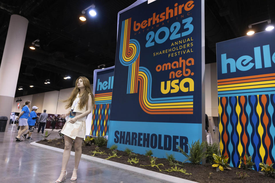 Wennie Wen of New York City poses for photos in the exhibition hall of the Berkshire Hathaway annual meeting on Saturday, May 6, 2023, in Omaha, Neb. (AP Photo/Rebecca S. Gratz)