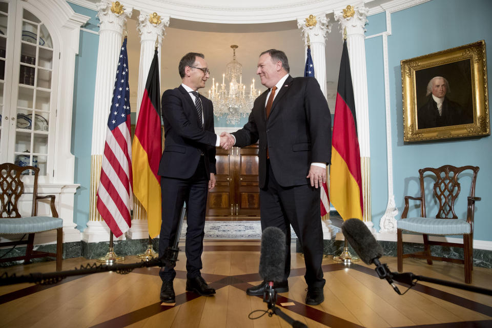 FILE - In this May 23, 2018 file photo Secretary of State Mike Pompeo shakes hands with German Foreign Minister Heiko Maas at the State Department in Washington. Germany’s foreign minister is setting out proposals for what he calls a future “balanced partnership” with the United States that would include setting up channels for financial payments which are independent of the U.S. (AP Photo/Andrew Harnik, file)