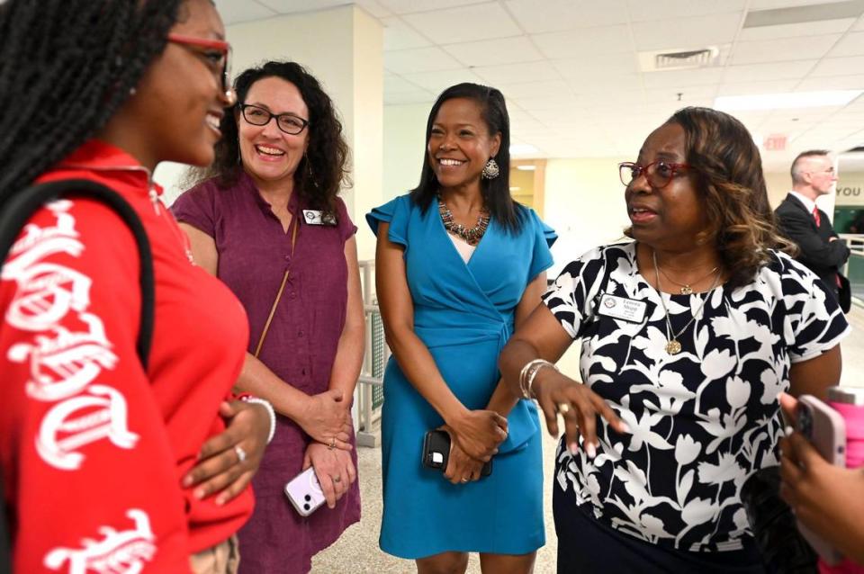 Ranson Middle School seventh grade student Falicia Evans, left, speaks with former CMS school board chair Elyse Dashew, superintendent Crystal Hill and school board member Lenora Shipp, right, prior to touring the school on Monday, August 28, 2023.