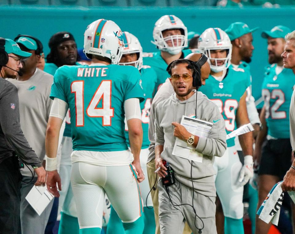 Miami Dolphins head coach Mike McDaniel and quarterback Mike White (14) during a preseason game at Hard Rock Stadium on Friday, August 11, 2023, in Miami Gardens, FL.