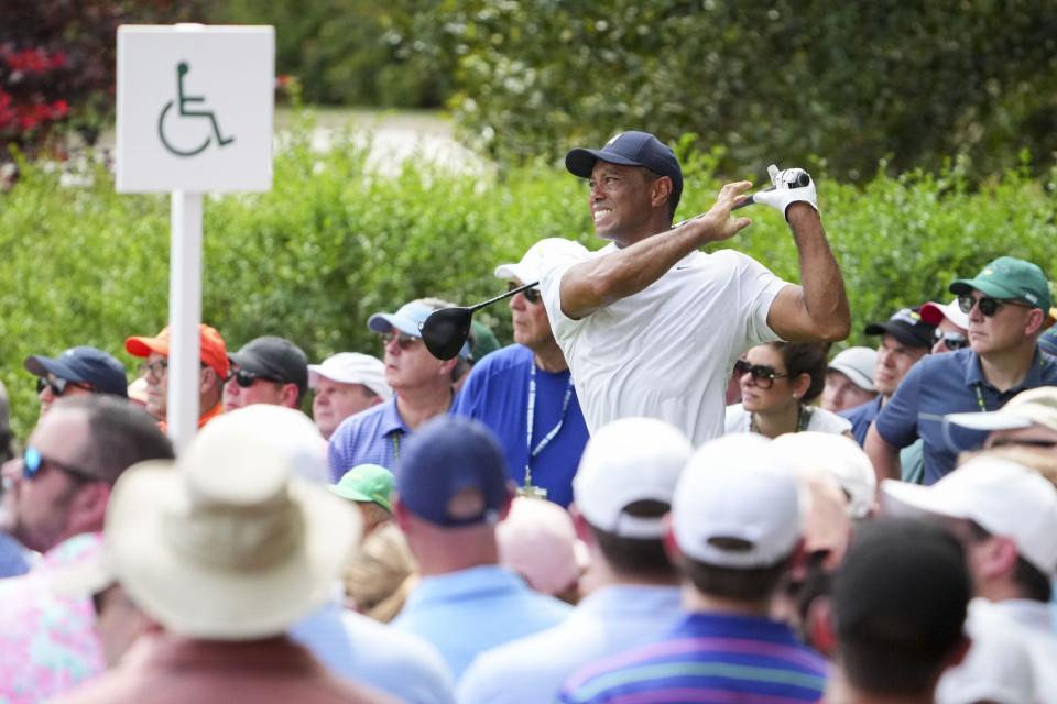 Tiger Woods tees off on the 14th hole during the first round of The Masters golf tournament.