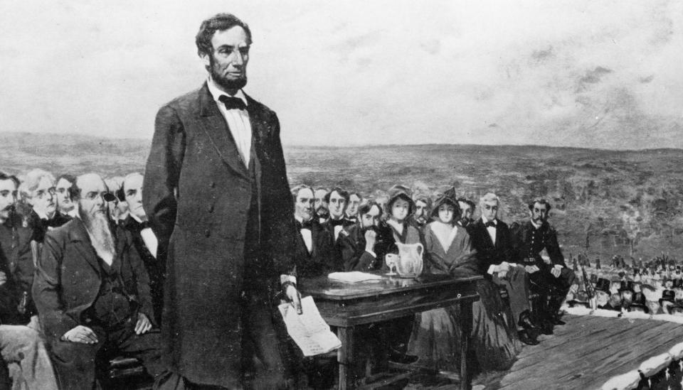 Lincoln at cemetery dedication ceremonies at Gettysburg where he delivered his famous address. He is allegedly seated beside the man with the tall hat.