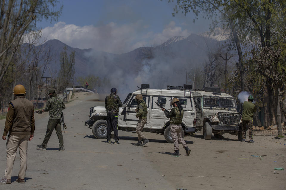 Indian policemen fire pellets and teargas shells at Kashmiri villagers as they throw stones and bricks at them during a protest near the site of a gunbattle in Pulwama, south of Srinagar, Indian controlled Kashmir, Friday, April 2, 2021. Anti-India protests and clashes have erupted between government forces and locals who thronged a village in disputed Kashmir following a gunbattle that killed three suspected militants. Police say the gunfight on Friday erupted shortly after scores of counterinsurgency police and soldiers launched an operation based on tip about presence of militants in a village in southern Pulwama district. (AP Photo/ Dar Yasin)