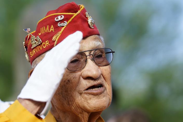 Navajo Code Talker Thomas Begay salutes the flag at the Arizona State Navajo Code Talkers Day celebration, Sunday, Aug. 14, 2022, in Phoenix. (AP Photo/Ross D. Franklin)