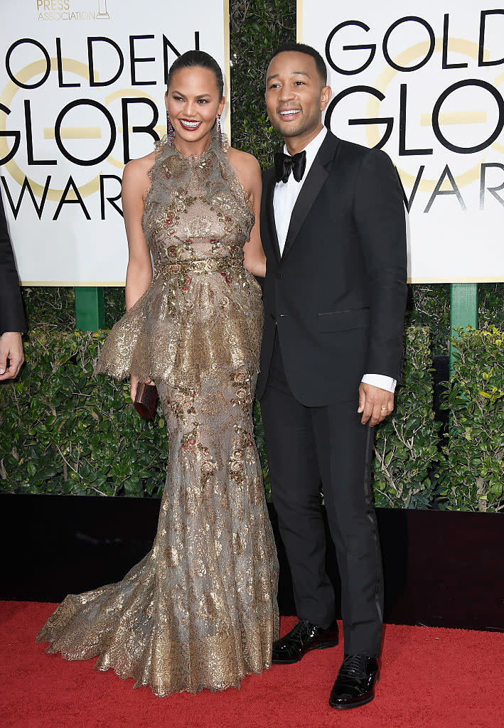 <p>John and Chrissy can barely contain their love for each other, and who can blame them? John looked sexy in a traditional tux while Chrissy looked as gorgeous as ever in a gold Marchesa number. </p>