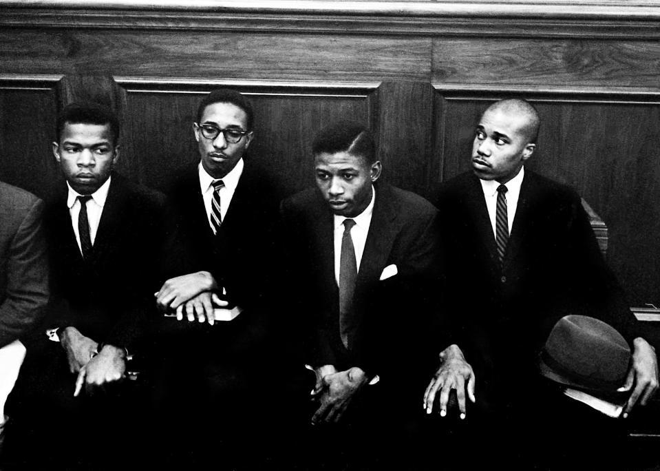 John Lewis, left, Bernard Lafayette, second from left, Paul Brooks, right, and another fellow sit-in demonstrator sit in a courtroom of the Nashville Court House Nov. 21, 1960, for a trial over their protesting at lunch counters in downtown Nashville.