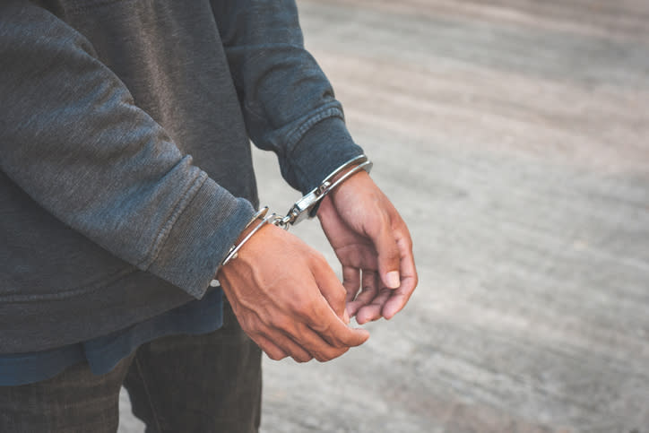 A man's hands handcuffed