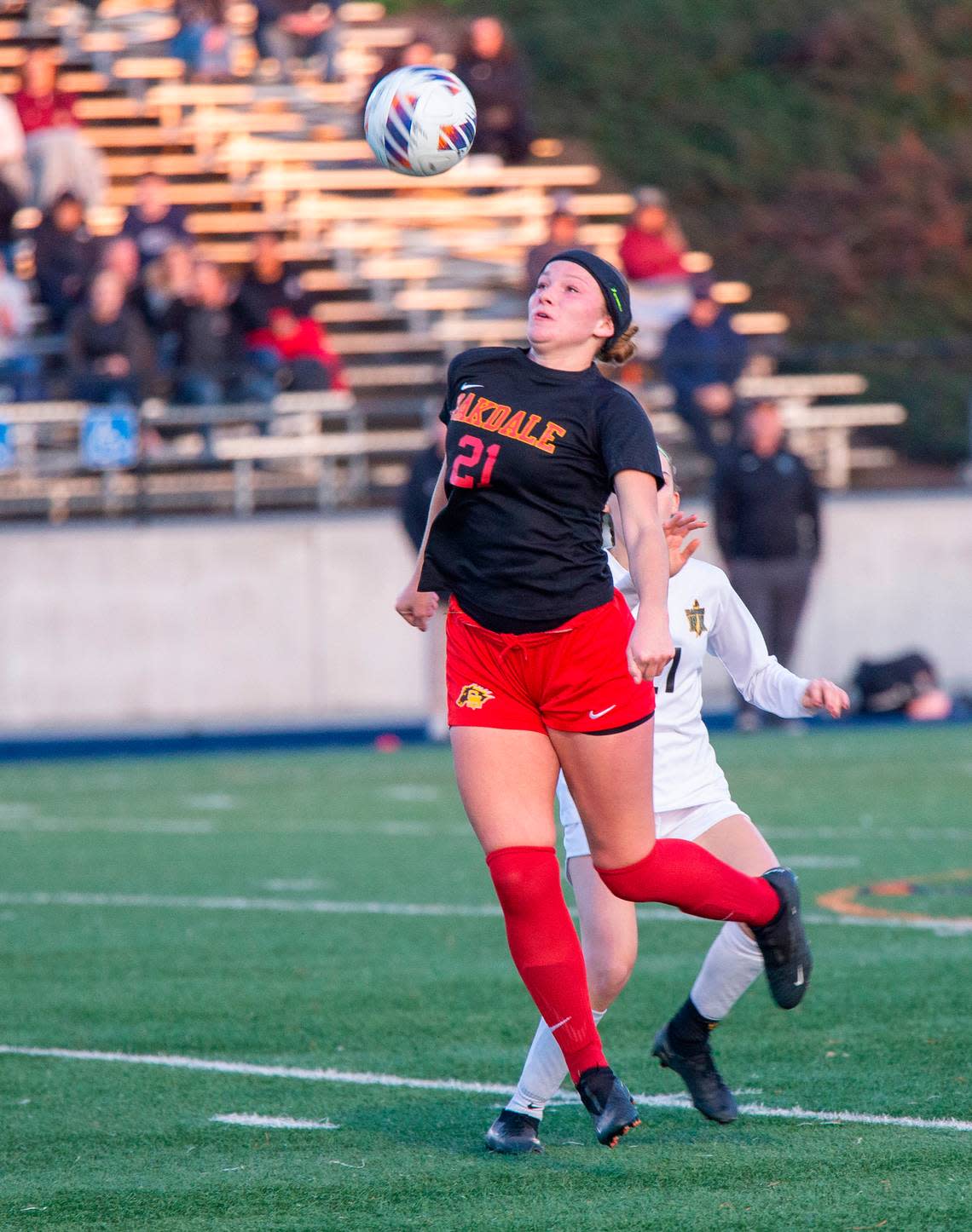 Oakdale High School's Kylie Melkonian, 21, hits a header during the Sac-Joaquin Division III sectional championship game against Rio Americano on Thursday, Feb. 22, 2024, at Cosumnes River College.