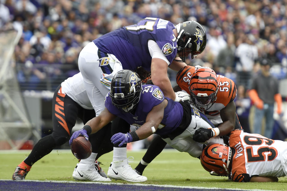 Baltimore Ravens running back Mark Ingram (21) dives in for a touchdown on a run as Cincinnati Bengals linebacker LaRoy Reynolds (55) and outside linebacker Nick Vigil (59) try to stop him during the first half of a NFL football game Sunday, Oct. 13, 2019, in Baltimore. (AP Photo/Gail Burton)