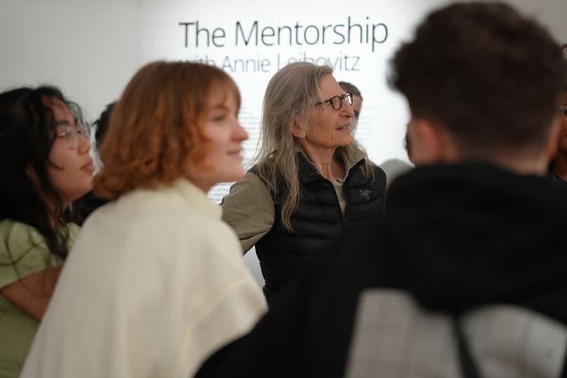 Annie Leibovitz and her mentees look at their work at the IKEA+ exhibition in Paris.