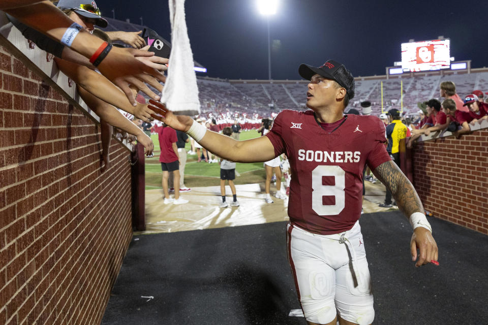 Oklahoma quarterback Dillon Gabriel slaps hand with fans on the way to the locker room following the team's win against SMU during an NCAA college football game Saturday, Sept. 9, 2023, in Norman, Okla. (AP Photo/Alonzo Adams)