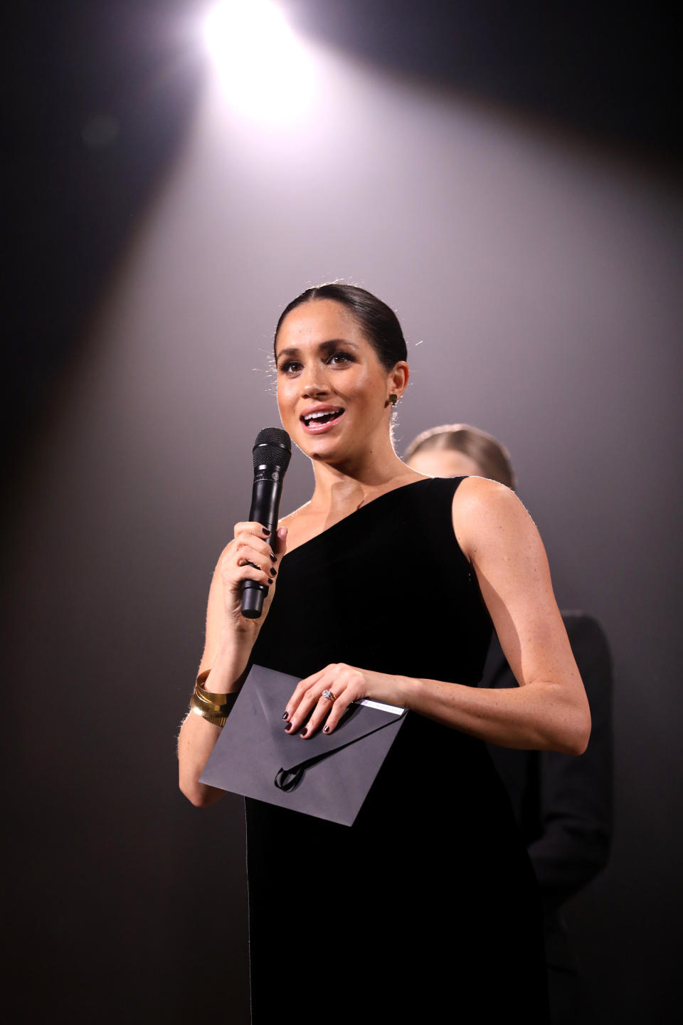 Props to the duchess for wearing a nail polish that appears to match the envelope she is holding. (Photo: Tristan Fewings/BFC via Getty Images)