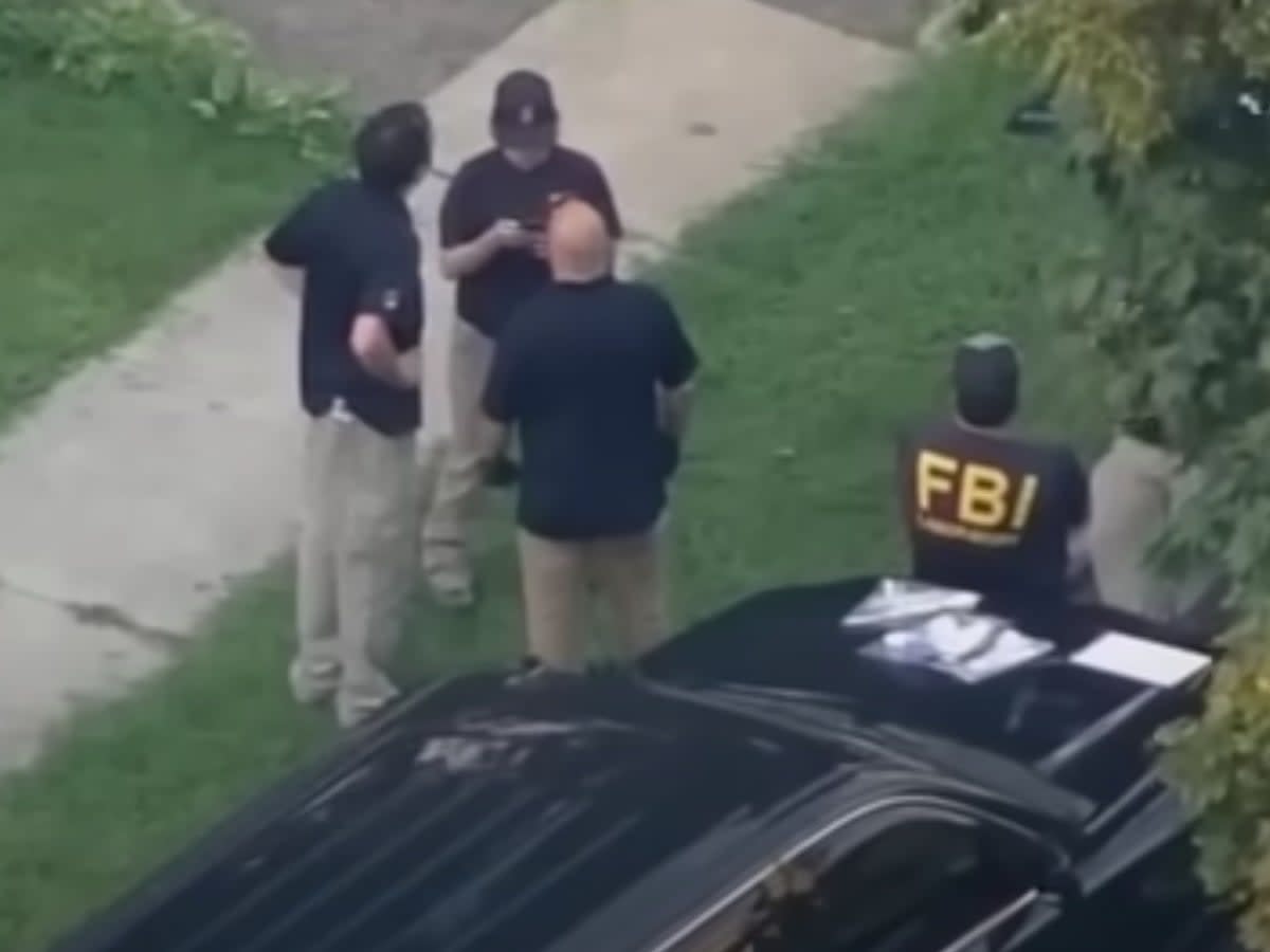 FBI agents wait outside of the home of a 17-year-old who has been accused of communicating with extremist organisations and plotting a terror attack (screengrab/ABC6)