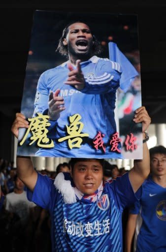 Shanghai Shenhua fans welcomes Didier Drogba as he arrives at Pudong international airport in Shanghai on July 14. Drogba will join French striker Nicolas Anelka, who signed with Shenhua in January on a deal believed to be nearly as high