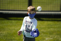 Tanner Cherry, 4, catches a ball before a spring baseball game between the Arizona Diamondbacks and the Milwaukee Brewers in Scottsdale, Ariz., Monday, March 1, 2021. (AP Photo/Jae C. Hong)