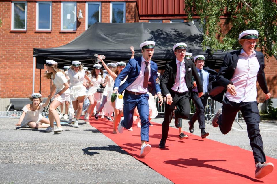<div class="inline-image__caption"><p>Students run out of their school celebrating their high school graduation at Nacka Gymnasium in Stockholm, Sweden.</p></div> <div class="inline-image__credit">Jessica Gow via Reuters</div>