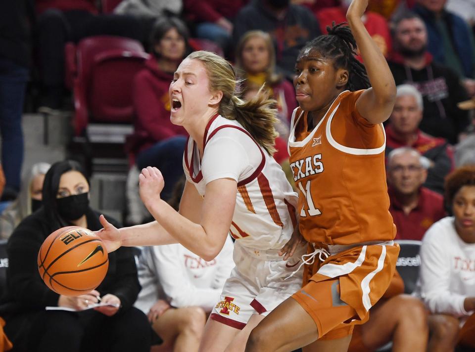 Iowa State's Emily Ryan (11) drives around Texas' Joanne Allen-Taylor (11) during the first half at Hilton Coliseum on Wednesday.