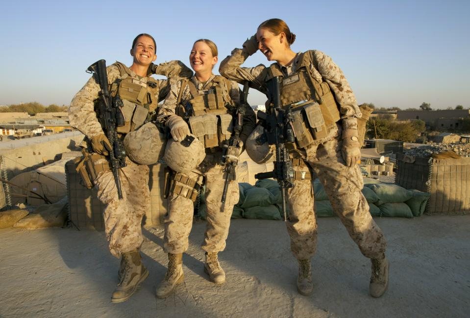 MUSA QALA, AFGHANISTAN - NOVEMBER 17: (SPAIN OUT, FRANCE OUT, AFP OUT) (L-R) Sargent Sheena Adams, 25, and Lance Corporal Kristi Baker, 21, and Hospital Corpsman Shannon Crowley, 22, US Marines with the FET (Female Engagement Team) 1st Battalion 8th Marines, Regimental Combat team II pose at their forward operating base on November 17, 2010 in Musa Qala, Afghanistan. There are 48 women presently working along the volatile front lines of the war in Afghanistan deployed as the second Female Engagement team participating in a more active role, gaining access where men can't. The women, many who volunteer for the 6.5 month deployment take a 10 week course at Camp Pendleton in California where they are trained for any possible situation, including learning Afghan customs and basic Pashtun language. (Photo by Paula Bronstein/Getty Images)