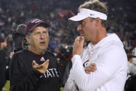 Mississippi State coach Mike Leach, left, talks with Mississippi coach Lane Kiffin before an NCAA college football game in Oxford, Miss., Thursday, Nov. 24, 2022. (AP Photo/Rogelio V. Solis)