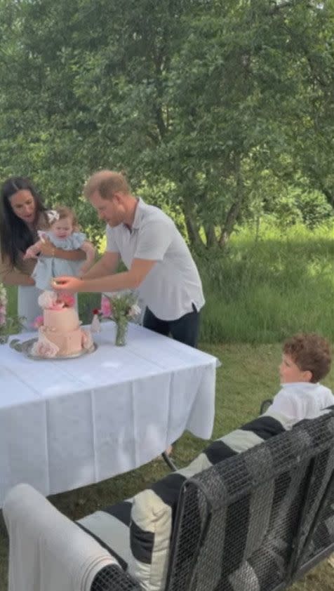 Prince Harry Meghan Markle Princess Lilibet blowing cake