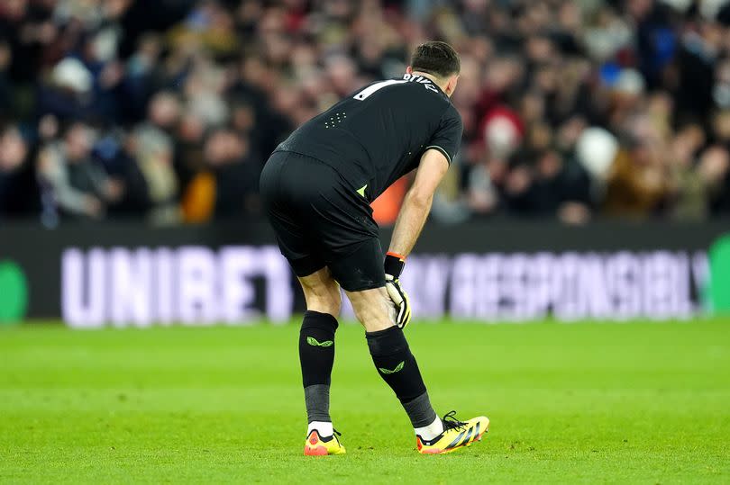 Aston Villa goalkeeper Emiliano Martinez stretches his hamstring during the Premier League match against Chelsea