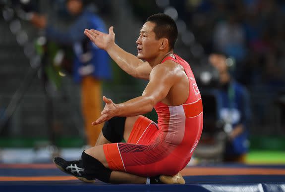 RIO DE JANEIRO, BRAZIL - AUGUST 21: Mandakhnaran Ganzorig (red) of Mongolia reacts following his defeat to Ikhtiyor Navruzov (blue) of Uzbekistan in the Men's Freestyle 65kg Bronze match against on Day 16 of the Rio 2016 Olympic Games at Carioca Arena 2 on August 21, 2016 in Rio de Janeiro, Brazil. (Photo by Laurence Griffiths/Getty Images)