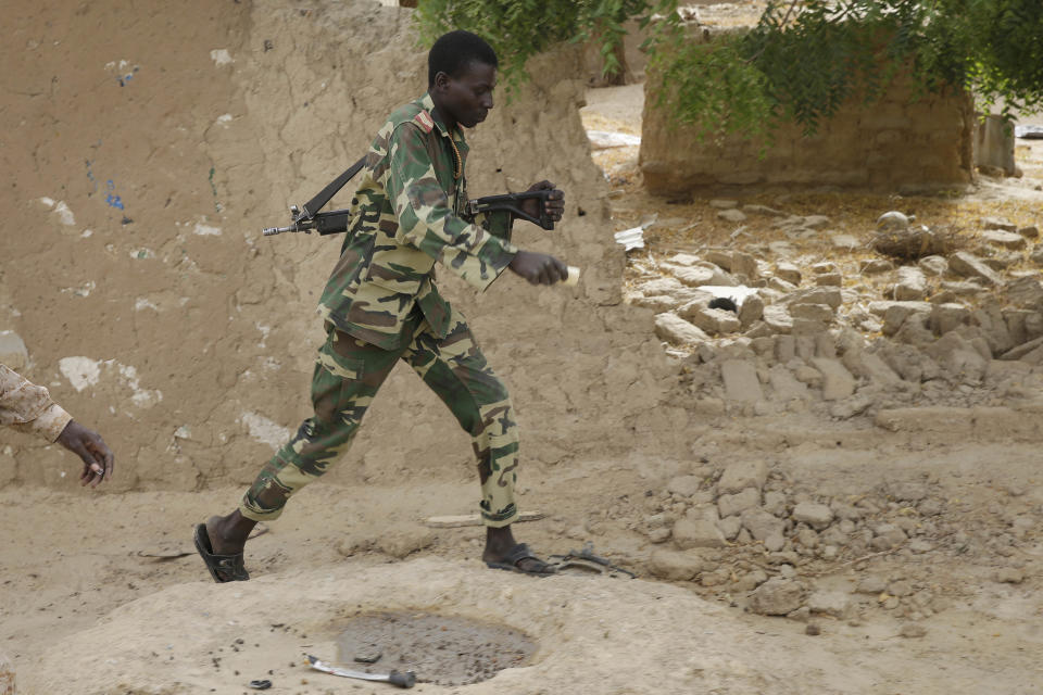 A Chadian soldiers walks in the city of Damasak, Nigeria, Wednesday, March 18, 2015. (AP Photo/Jerome Delay)