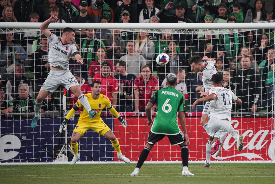 St. Louis City SC midfielder Eduard Lowen, left, heads the ball away from goalkeeper Roman Burki and others as Austin FC midfielder Daniel Pereira looks on during the second half. Austin FC's next match will be Saturday at home against Montreal.