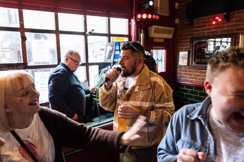 Customers enjoying karaoke at Coopers