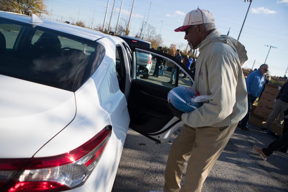 Volunteers hand out turkeys at Kingswood Community Center Friday, Nov. 19, 2021.