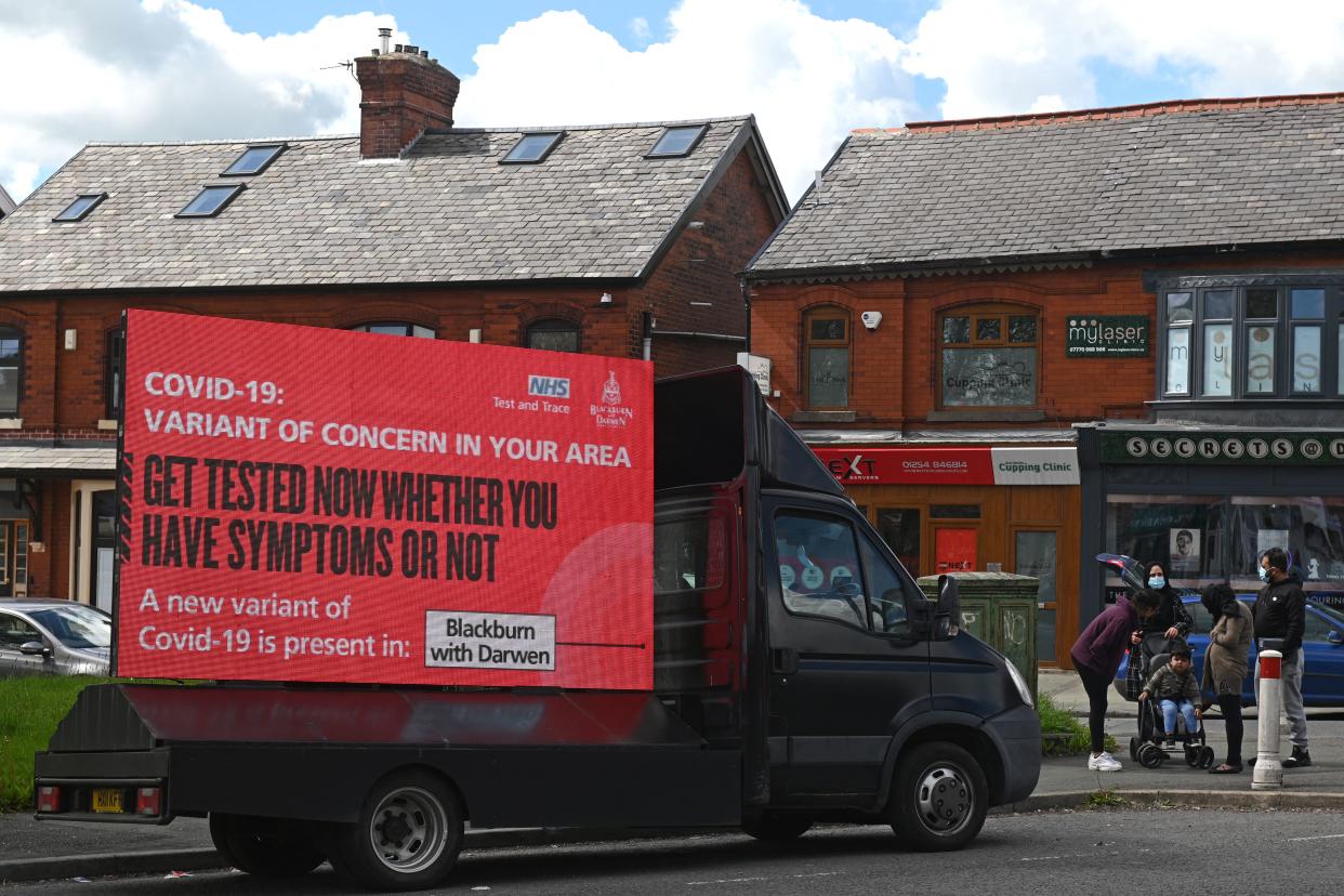 Information advising people to get tested due to the prevalence of a coronavirus covid-19 variant is displayed on a screen attached to a vehicle on the streets of Blackburn, in north-west England on May 19, 2021. - British Prime Minister Boris Johnson said Wednesday that Covid-19 vaccines are proving effective against a highly contagious coronavirus variant, first discovered in India, as he was pressed on why the government is allowing travel from hotspots. (Photo by Oli SCARFF / AFP) (Photo by OLI SCARFF/AFP via Getty Images)