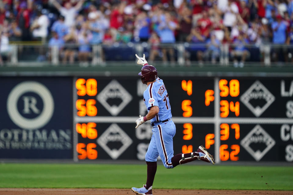 Philadelphia Phillies' Rhys Hoskins rounds the basses after hitting a home run off of Washington Nationals starting pitcher Paolo Espino during the first inning of a baseball game, Thursday, Aug. 4, 2022, in Philadelphia. (AP Photo/Matt Rourke)