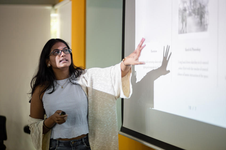 Woman presenting a PowerPoint slide during a work-related seminar