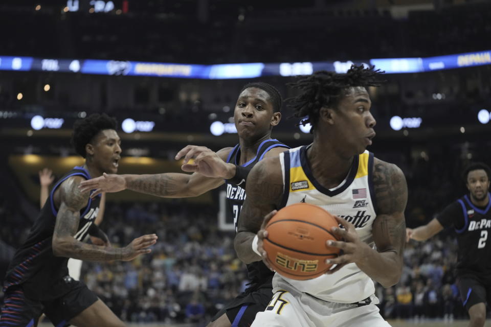 Marquette's Zaide Lowery looks to pass in front of DePaul's Elijah Fisher during the first half of an NCAA college basketball game Wednesday, Feb. 21, 2024, in Milwaukee. (AP Photo/Morry Gash)