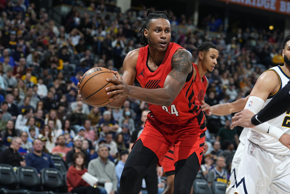 Portland Trail Blazers forward Jabari Walker, left, pulls in a rebound in the second half of an NBA basketball game against the Denver Nuggets, Sunday, Feb. 4, 2024, in Denver. (AP Photo/David Zalubowski)