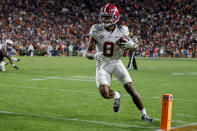 Alabama wide receiver John Metchie III (8) catches a pass to score during the fourth overtime of an NCAA college football game to defeat Auburn Saturday, Nov. 27, 2021, in Auburn, Ala. (AP Photo/Butch Dill)