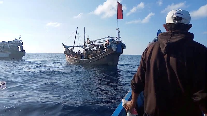 A boat carries Rohingya people stranded at sea