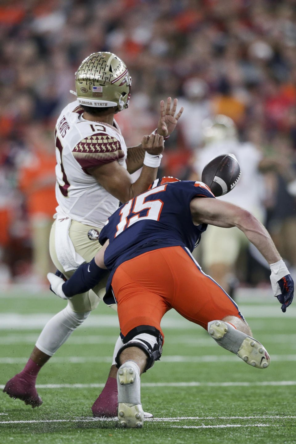 Syracuse linebacker Derek McDonald (15) forces a fumble by Florida State quarterback Jordan Travis (13) during the first half of an NCAA college football game Saturday, Nov. 12, 2022, in Syracuse, N.Y. (AP Photo/Joshua Bessex)