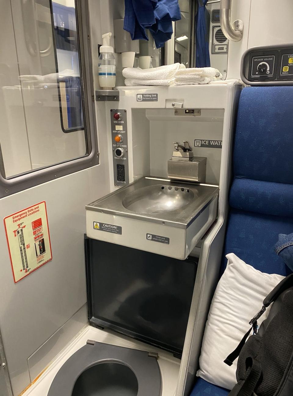 a toilet, sink, and mirror on an Amtrak train