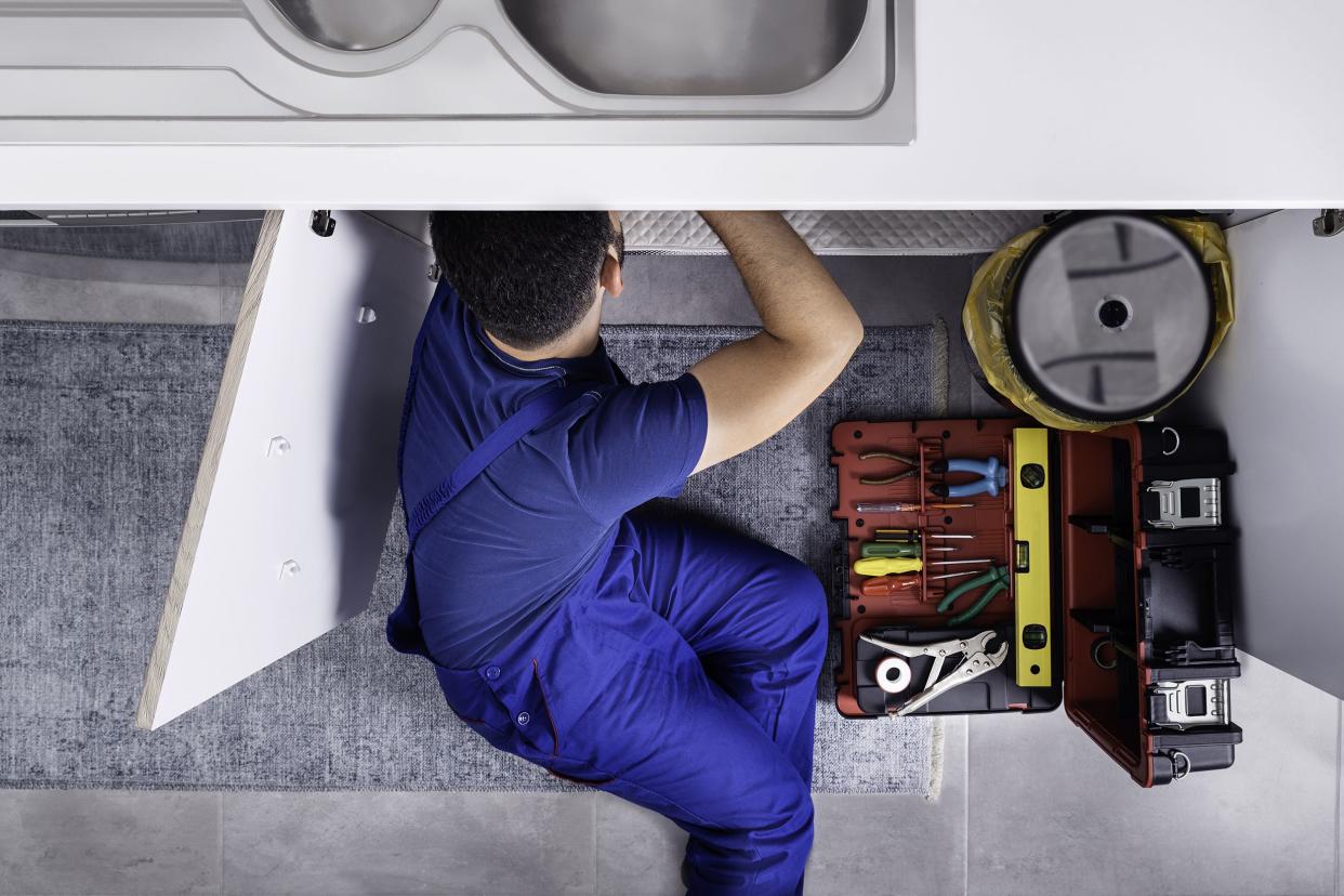 plumber working on sink