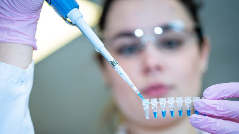 Person with pipette in lab