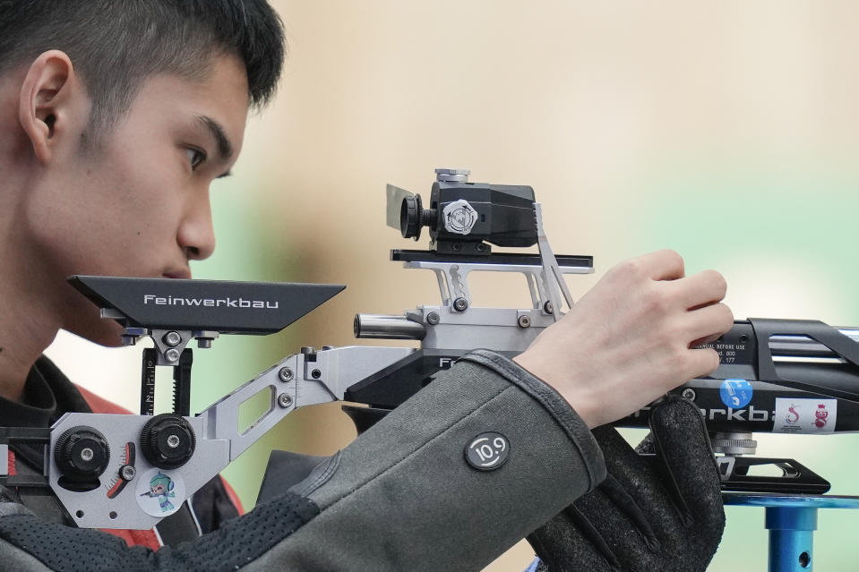 China's Shen Lihao competes in 10m air rifle shooting qualifying at the Fuyang Yinhu Sports Centre in the 19th Asian Games in Hangzhou, China, Tuesday, Sept. 26, 2023. (AP Photo/Vincent Thian)